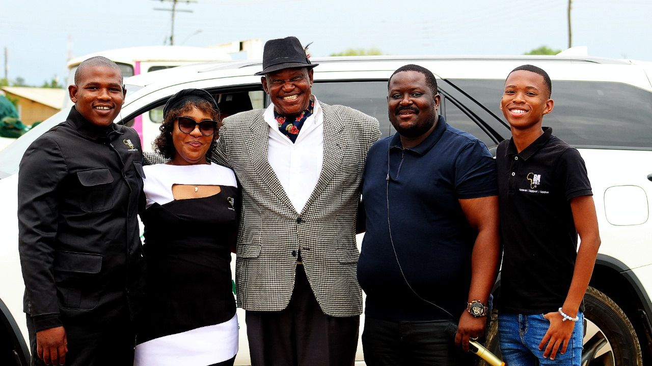 BaAfrica leadership and staff together beside a company vehicle