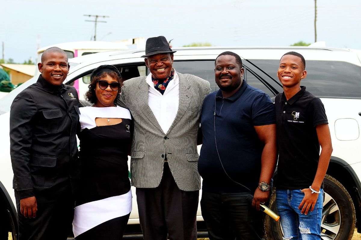 BaAfrica leadership and staff together beside a company vehicle