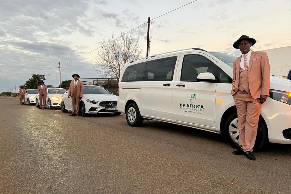 The BaAfrica fleet lined up at dawn with drivers standing by each vehicle