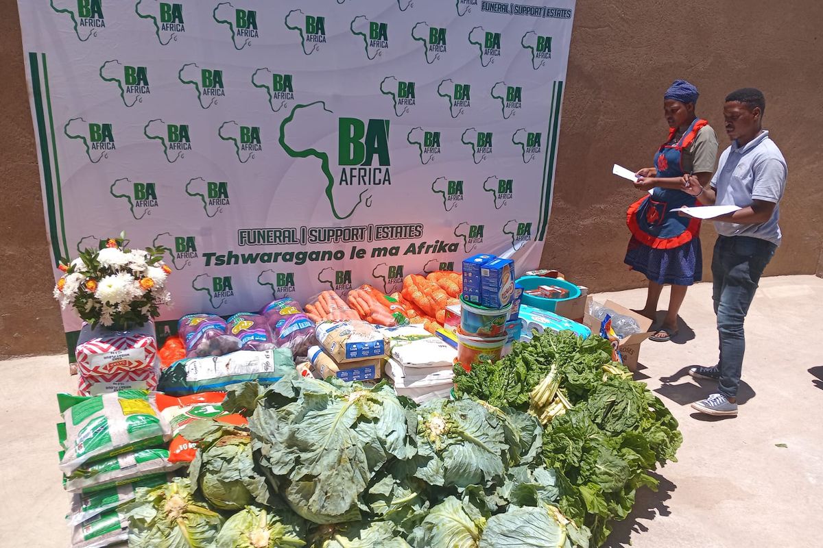 A BaAfrica grocery delivery laid out in front of the company banner