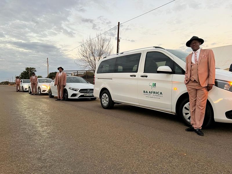 The BaAfrica fleet lined up at dawn with drivers standing by each vehicle
